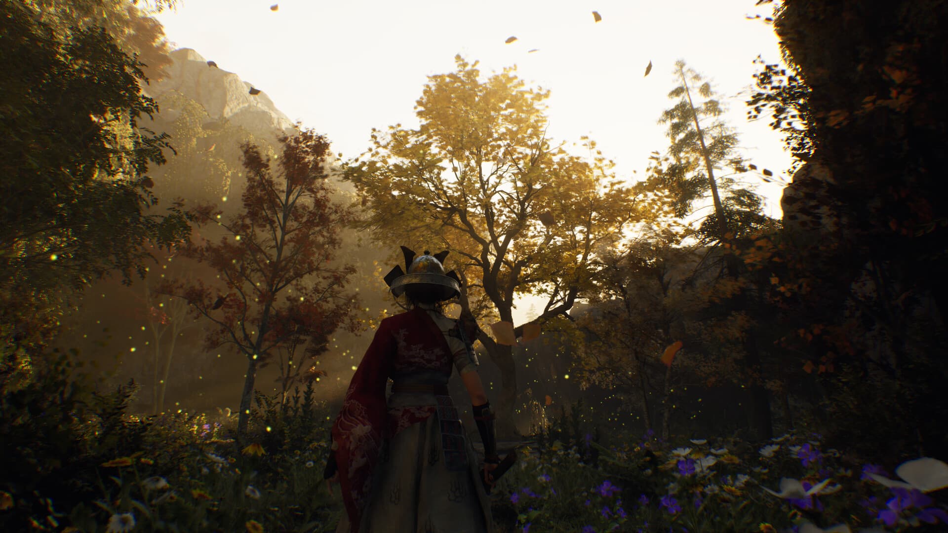 A cloaked character explores a sunlit wooded path.